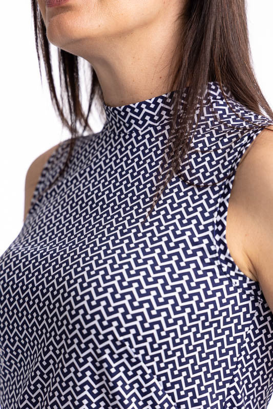 Close front view of the collar on the On The Edge Sleeveless Golf Top in Chic Chevron print. This is a white chevron print on a blue background. This top features a back zipper and a feminine scallop design along the hemline.