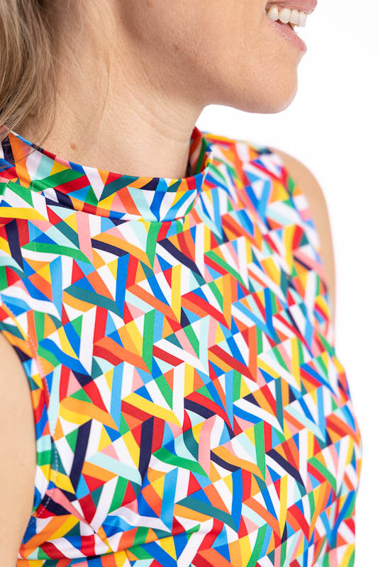 Close front view of the neckline on the On The Edge Sleeveless Golf Dress in K All Day print. The K All Day print is an abstract confetti-style mirrored K-shaped pattern in red, orange, yellow, green, blue, black and white.