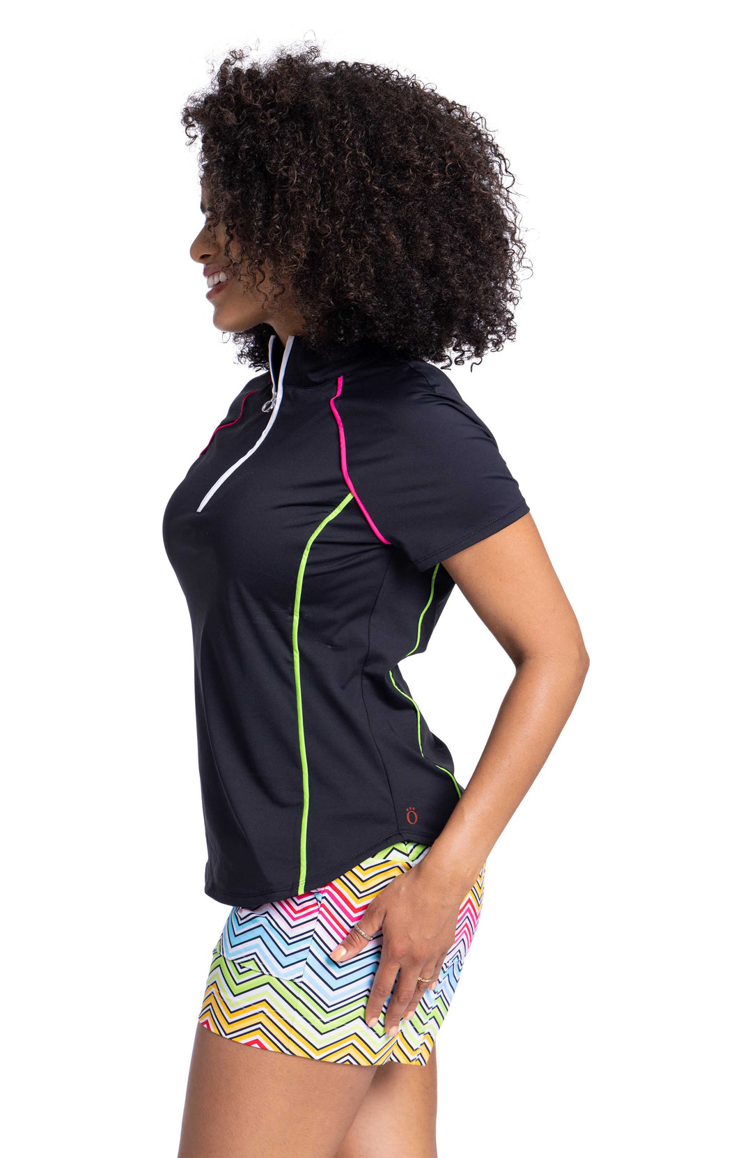 Woman's black golf shirt with pink and yellow piping and multicolored shorts