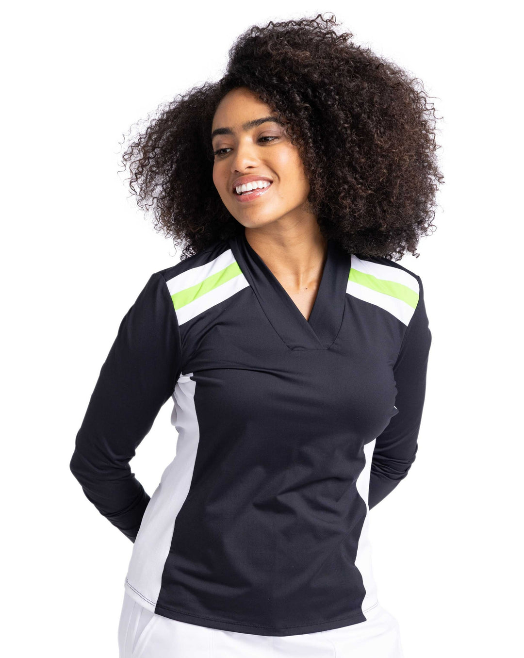 Front view of a woman smiling wearing a black longsleeve top with white and green stripes on shoulders and white contrasting side panels. 