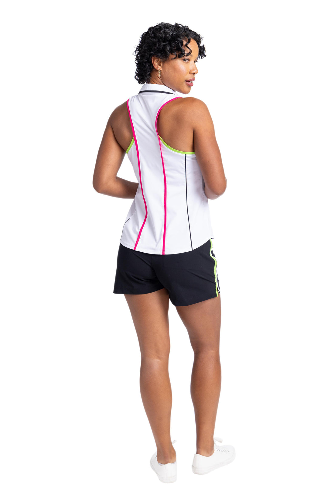 Women wearing a racerback white top with pink pippin on the back princess seams and black pipping on the back-side princess seams. 