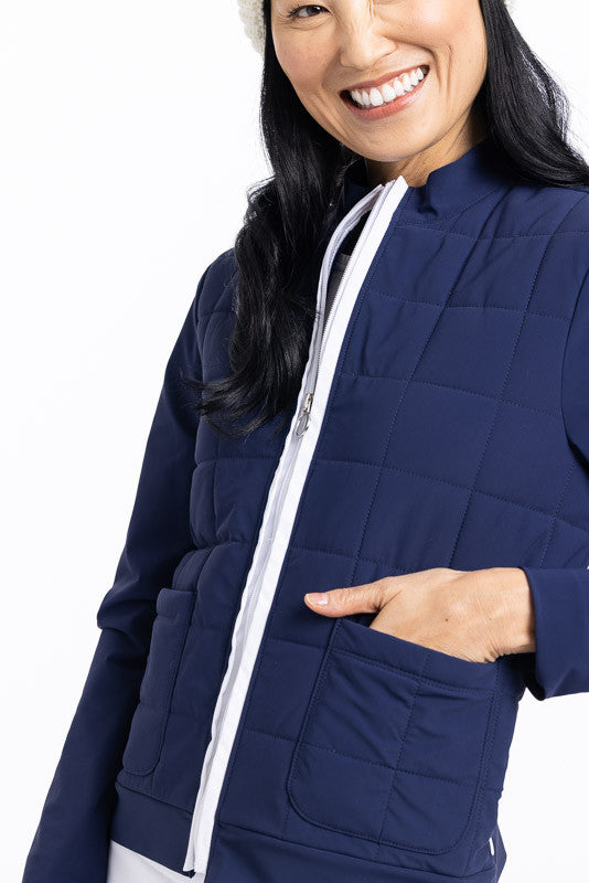 Smiling woman wearing a navy blue Quilted and Cozy Jacket