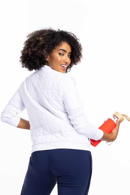 Back view of a smiling woman wearing a white Quilted and Cozy Jacket