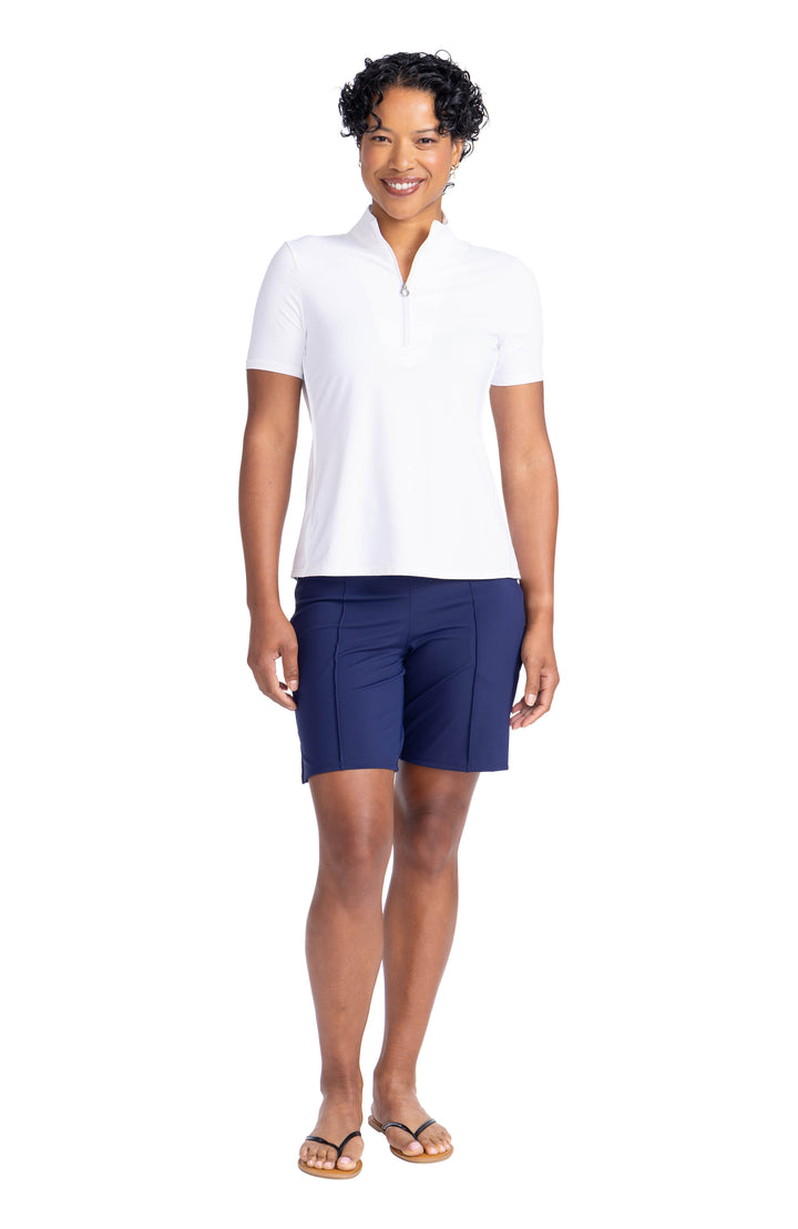 women standing wearing white keep it covered shortsleeve top with navy blue shorts and flip flops