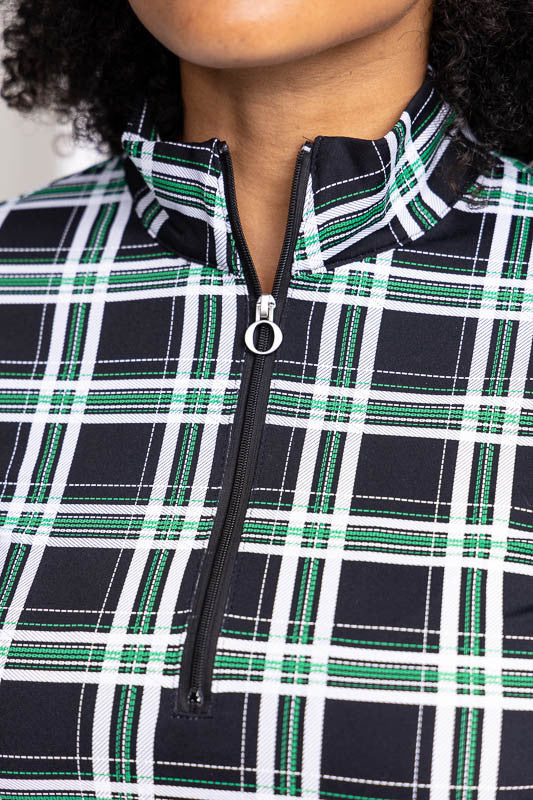 Close front view of the neckline and the reinforced "O" zipper pull on the Keep It Covered Long Sleeve Golf Top in Tartan Plaid and the No Hat Hair Visor in white.