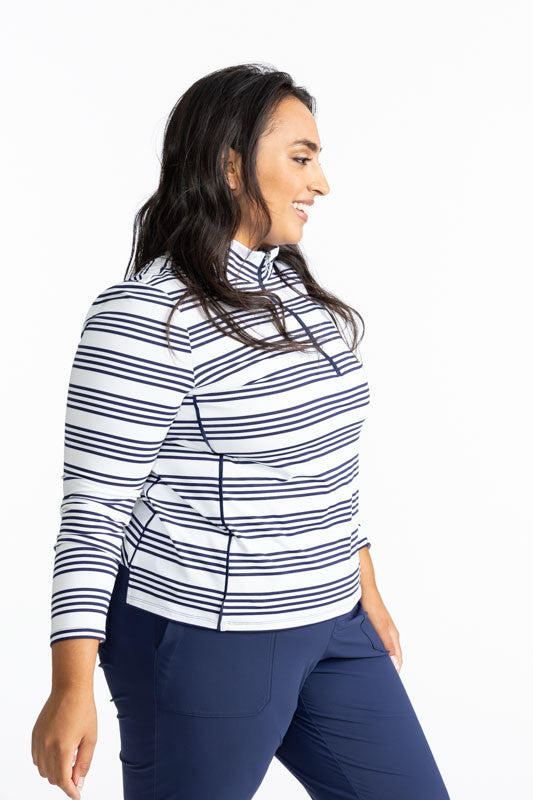 Right side view of the Keep It Covered Long Sleeve Golf Top in Shutter Stripe. This pattern is a grouping of four horizontal, navy blue stripes with white space in between from top to bottom on this top.