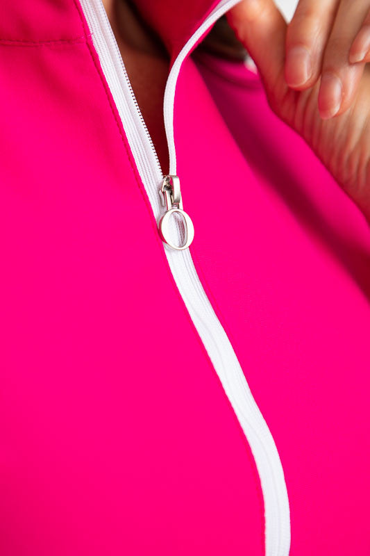 Tight view of the zipper front on the Keep It Covered Long Sleeve Golf Top in Magenta Pink.