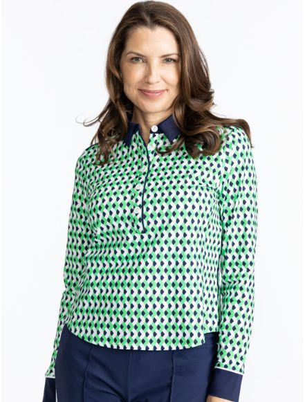 Smiling woman wearing the At The Pin Long Sleeve Golf Top in Chevron Kelly Green. The collar on this top is solid navy blue as well as the cuffs on each arm of this top.