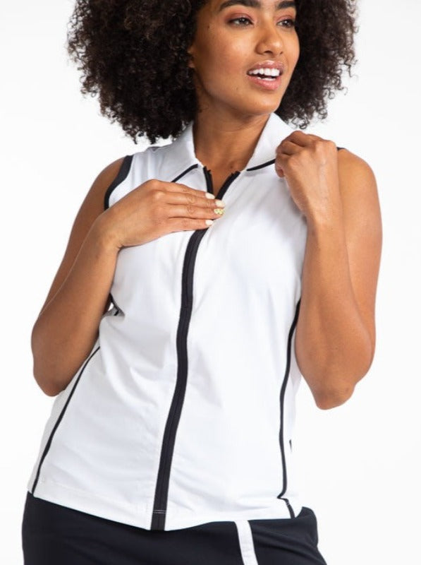Front view of a woman golfer wearing the Swing Away Sleeveless Golf Top in White. This top has black accents down the front zipper,  around each sleeve, and two stripes on each side. 