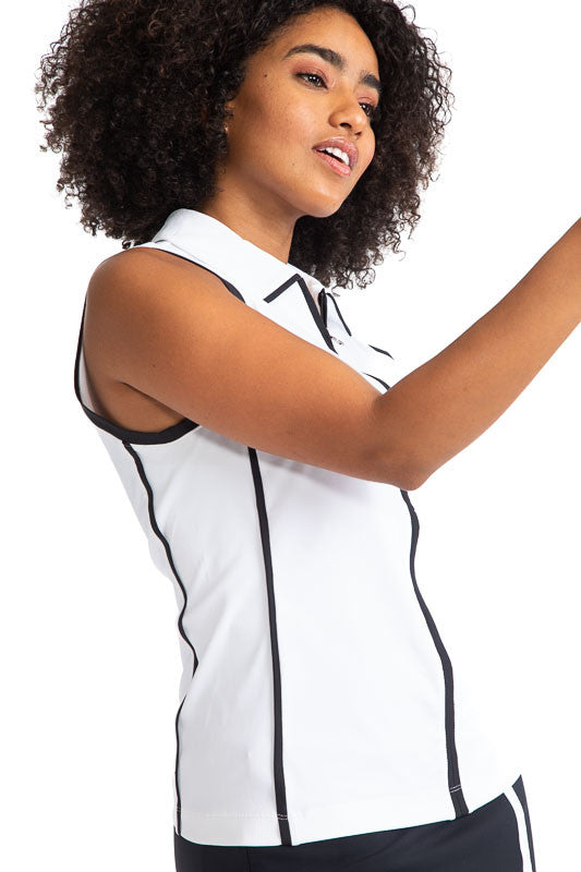 Right side view of a woman golfer wearing the Swing Away Sleeveless Golf Top in White. This top has black accents down the front zipper,  around each sleeve, and two stripes on each side. 