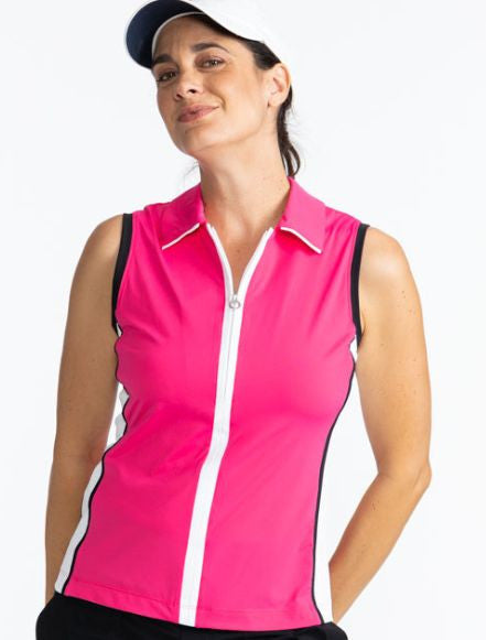 Close front view of a smiling woman wearing the We've Got You Covered Hat in White and the Swing Away Sleeveless Golf Top in Preppy Pink. This is a solid Preppy Pink top trimmed in black around each armhole, a white front zipper, and a white side section 