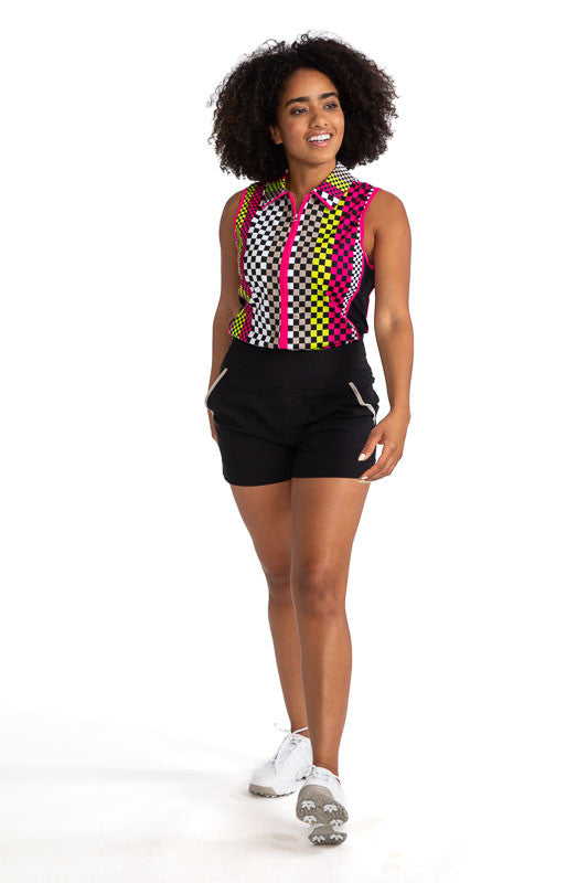Full front view of a woman golfer wearing the Swing Away Sleeveless Golf Top in Checks Mix Print and the Carry My Cargo Golf Shorts in Black.