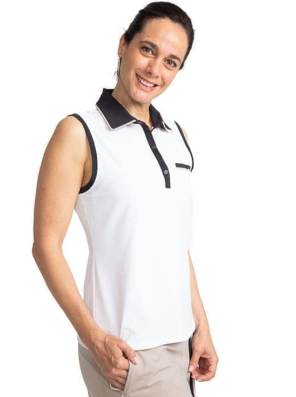 Smiling woman golfer wearing the Sun Seeker Sleeveless Golf Top in White. This shirt has black accents around each sleeve, the collar and front snaps as well as a faux front pocket on the left side.