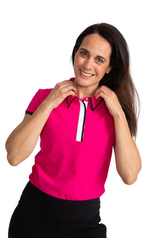 Front view of a smiling woman golfer wearing the Up and In Short Sleeve Golf Top in Magenta Pink.