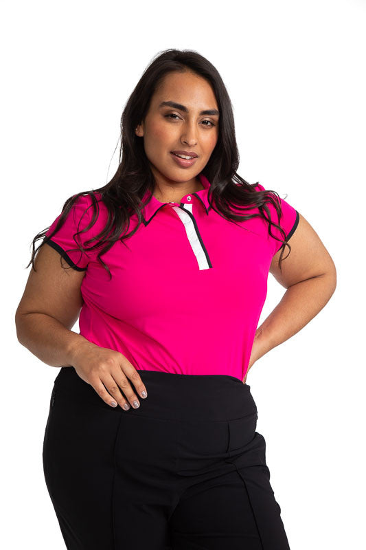 Front view of a woman golfer wearing the Up and In Short Sleeve Golf Top in Magenta Pink.