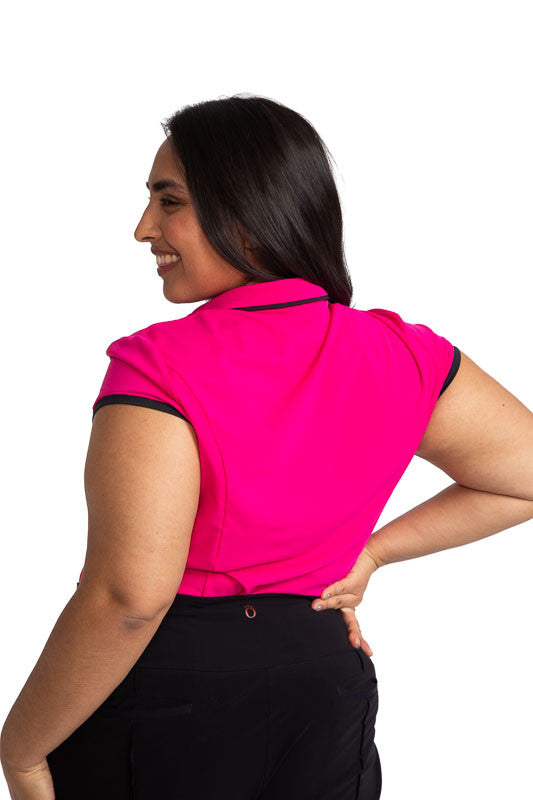 Back view of a woman golfer wearing the Up and In Short Sleeve Golf Top in Magenta Pink.