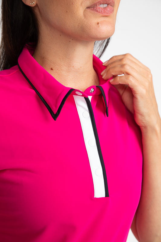 Tight front view of the collar and front snaps on the Up and In Short Sleeve Golf Top in Magenta Pink.