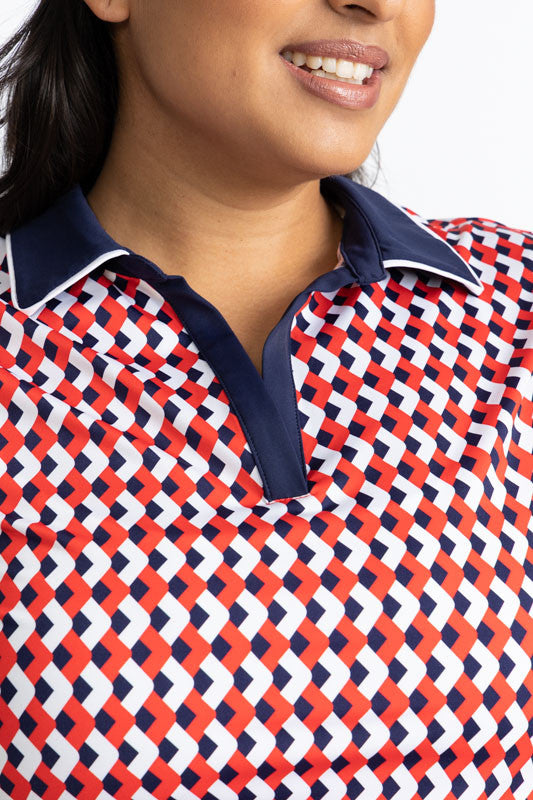 Close front view of the neckline on the Classic and Fantastic Short Sleeve Golf Top in Chevron Tomato Red. In this view, you can see the navy blue collar and v-neck as well as the white trim around the outside of the collar. 