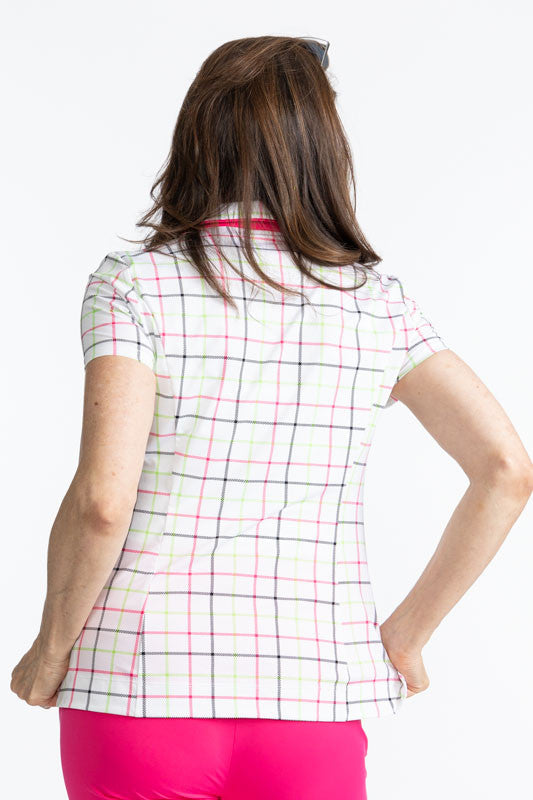 Back view of the Classic and Fantastic Short Sleeve Golf Top in Tattersall Plaid. This top has a Preppy Pink V-neck, with the collar also trimmed in Preppy Pink. The print consists of overlapping stripes of Preppy pink, Fairway green, and black on a white
