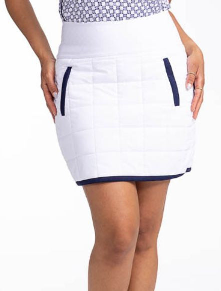 Front view of the Quilted and Cozy Golf Skort in White/Navy Blue. This is a white, quilted skort with navy blue trim around the hemline and two front zippered pockets with navy blue trim. There is also a back welt pocket on the waistband that can hold a g
