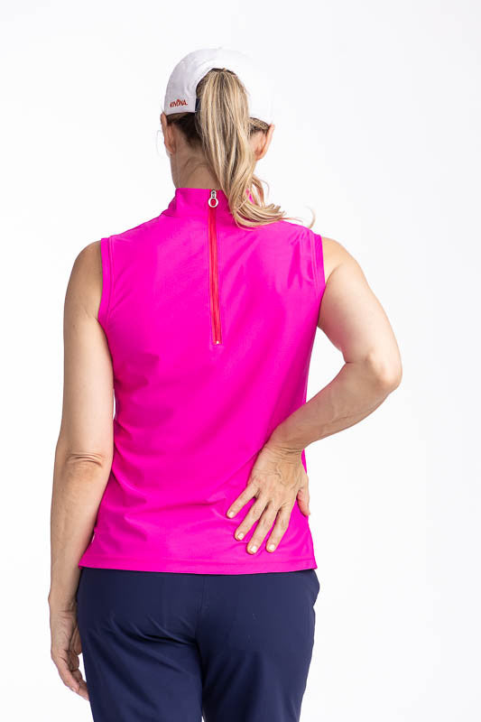 Back view of the No Break Sleeveless Golf Top in Open Air Pink. This is a bright pink top with two vertical stripes in white and navy blue that run from the left shoulder to the hem. This top also features a mock collar and a back zipper.