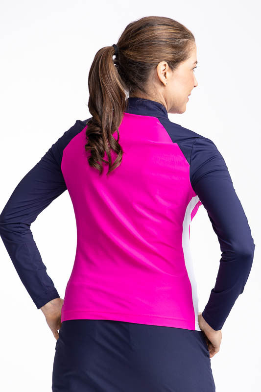 Back view of the Cap to Tap Long Sleeve Golf Top in Open Air Pink. This top is a solid pink top with navy blue sleeves and neckline and white stretch rib sides.