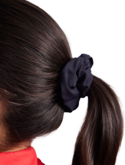 Close up of the black scrunchie in the Super Scrunchie Threesome Black Pack. This pack also includes one pink and one black and white patterned scrunchie.