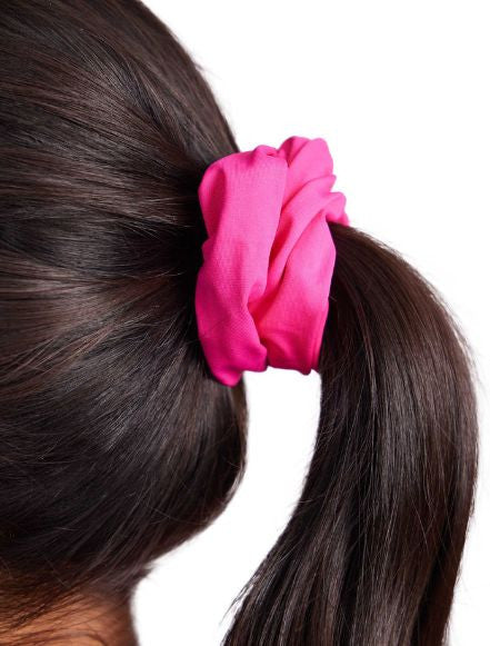 Close up of the pink scrunchie in the Super Scrunchie Threesome Black Pack. This pack also includes one black and one black and white patterned scrunchie.