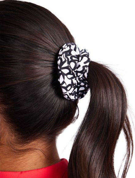 Close up of the black and white patterned scrunchie in the Super Scrunchie Threesome Black Pack. This pack also includes one solid black and one pink scrunchie.