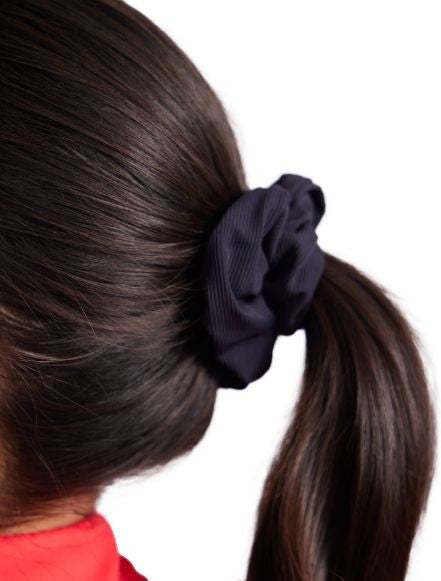 Close view of the black scrunchie in the Super Scrunchie Threesome Basic Pack. It also includes one scrunchie in white and one in navy blue. 