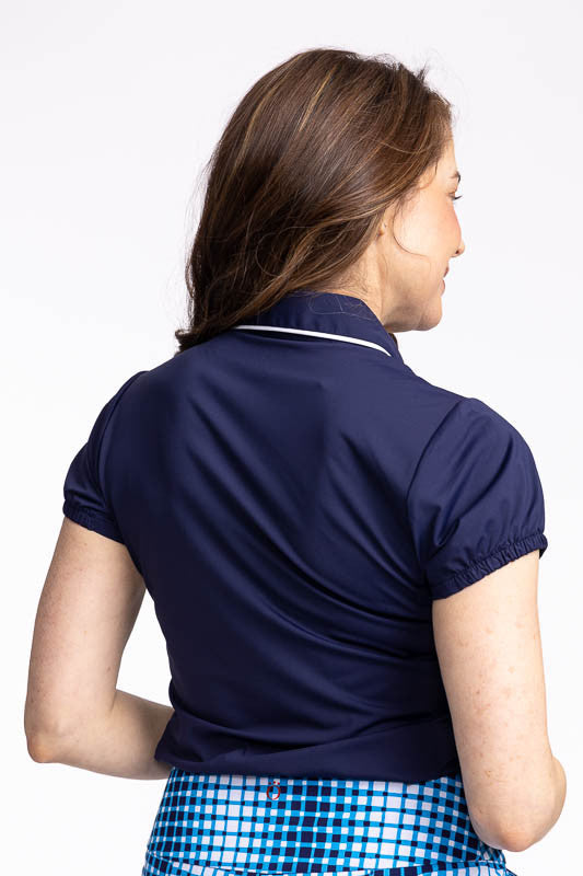 Back view of the Prettier Than A Polo Short Sleeve Golf Top in Navy Blue. This is a solid navy blue top with a quarter zip front with white piping around the collar. 