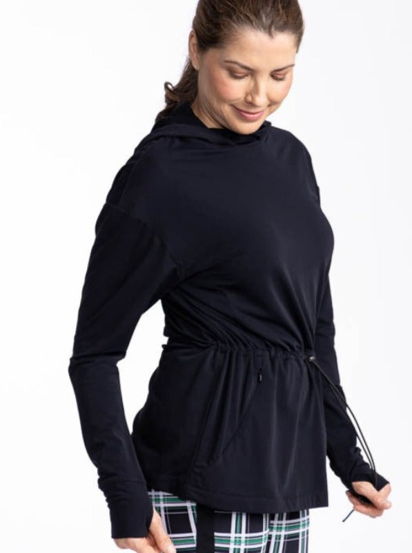 Left side view of a woman wearing the Aprés 18 Anorak Long Sleeve Hoodie in black.