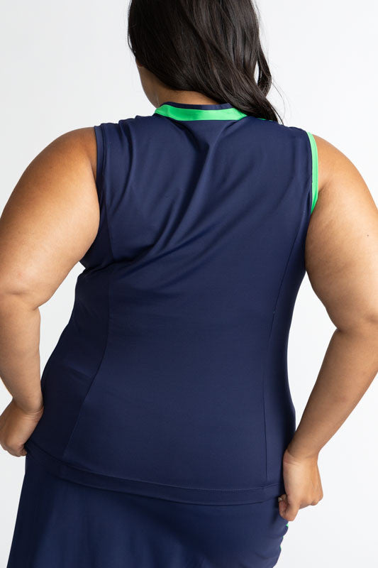 Back view of the Tend the Flag Sleeveless Golf Top in Navy Blue. This top features a navy blue background with a diagonal white stripe and a section of Kelly green from the top of the left shoulder down to just below the bust on this top. the right armhol