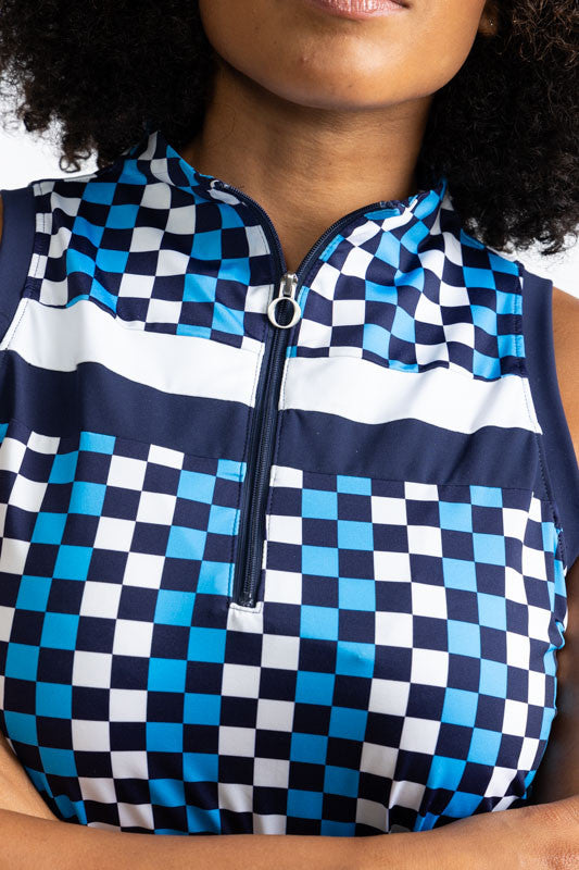 Close front view of the neckline, quarter zip and the two stripes on the On Target Sleeveless Golf Top in Check It Out print. This print is made up of French blue, navy blue, and white checks forming a vertical pattern and has one thick white stripe and o