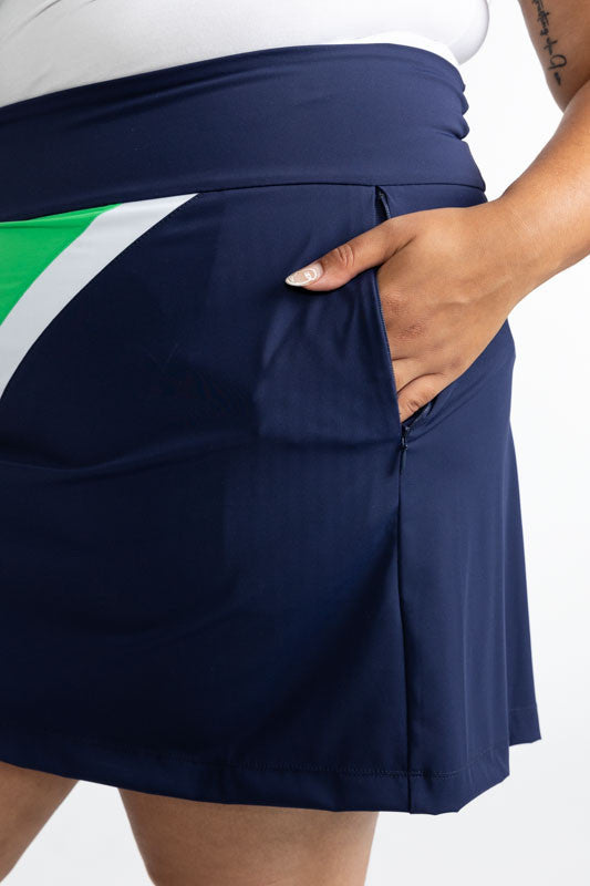 Close left side view of the Tend the Flag Golf Skort in Navy Blue. You can see one of the two side pockets on the skort in this view.