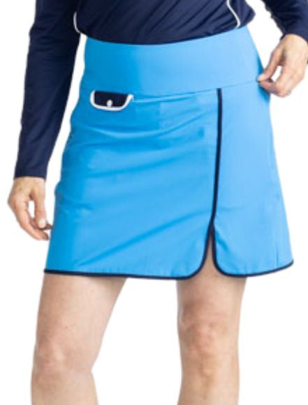 Close front view of the Club Champion Golf Skort in French Blue. This skort is solid French Blue with black trim around the bottom and up the split on the front of the skort. There is also a front flap pocket in black with white trim and a white snap.