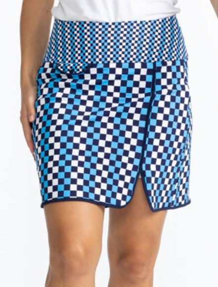 Close front view of the Club Champion Golf Skort in Check It Out print. This print is a mix of French blue, black, and white checks on this skort with navy blue trim around the bottom and up the split on the skort. There is a front flap pocket with black 