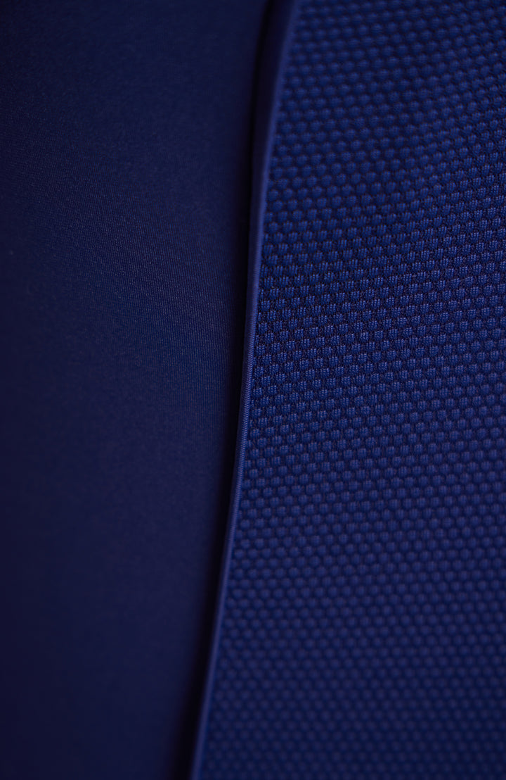 Image of navy blue fabric, princess seam binding, and side mesh panel. 