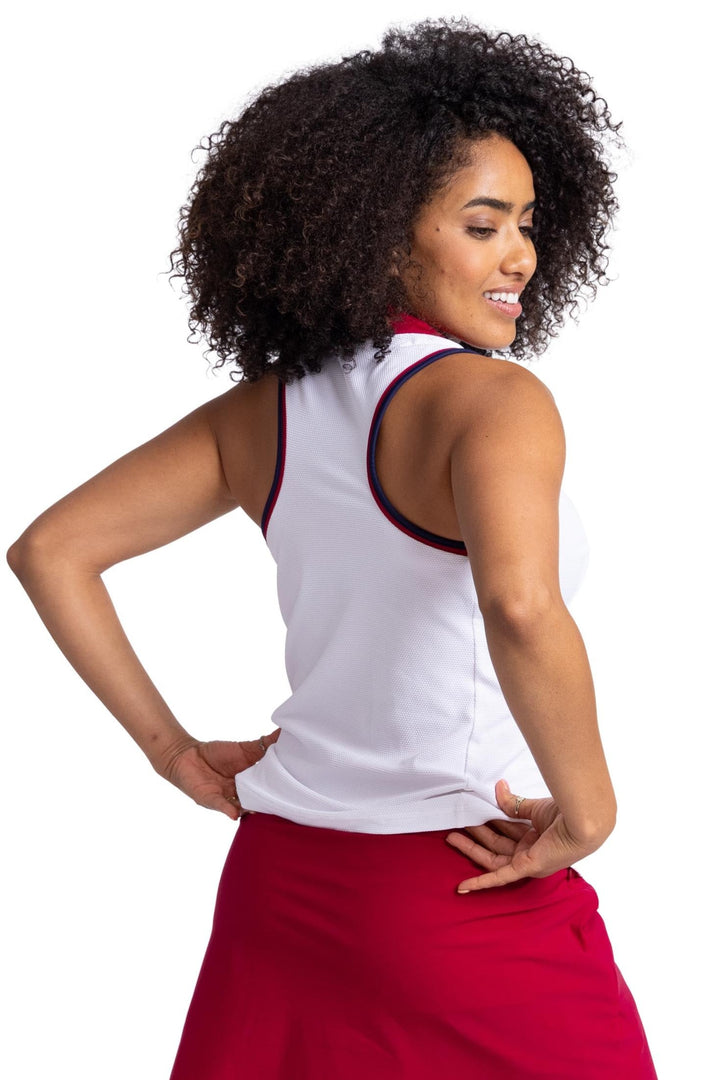 Back view of a women wearing white racerback top with contrasting navy blue and Bordeaux red binding on the armholes and neckline. 