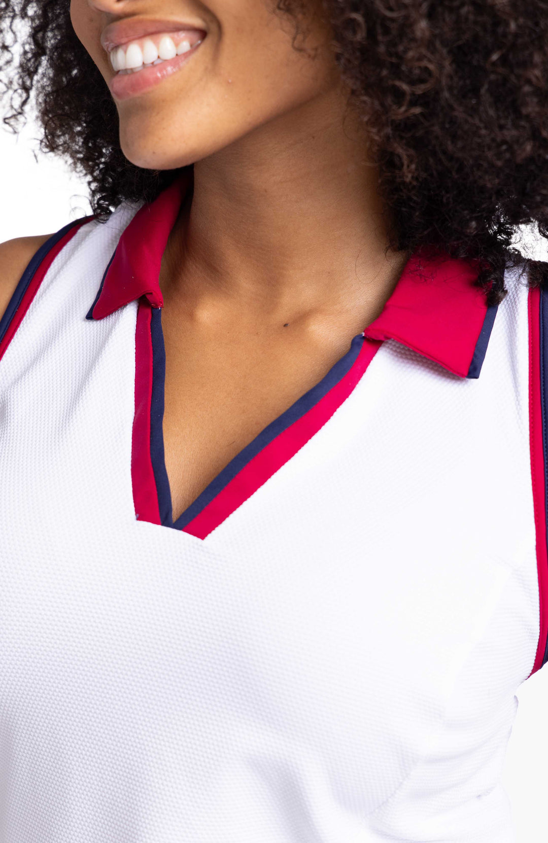 Close detailed view of a women wearing white racerback top with contrasting navy blue and Bordeaux red binding on the armholes and neckline; and a Bordeaux red collar. 