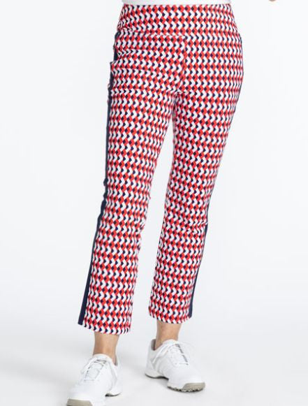 Front view of the Smooth Your Waist Crop Pants in Chevron Tomato Red. The Chevron Tomato Red print is comprised of red, white, and blue chevrons in a repeating pattern on the pants with a navy blue stripe that runs down each side. 