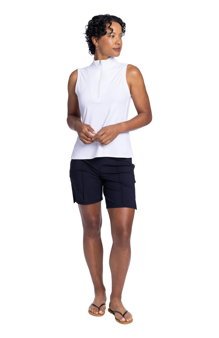 Full view of a woman wearing the Keep It Covered Sleeveless golf top and black Golf Glove Friendly short.