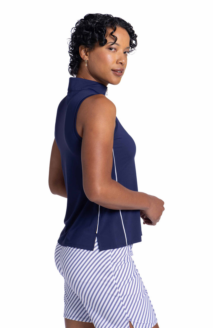 Side view of a woman wearing a Keep It Covered Sleeveless Golf Top in navy blue.