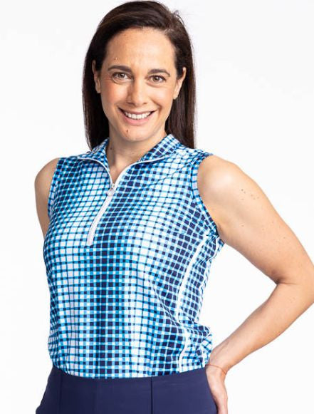 Close front view of the Keep It Covered Sleeveless Golf Top in Ocean Plaid. The ocean plaid print is a vertical repeating gradient white to blue checkered print. The top features a white quarter zip front and two white stripes running down the side.