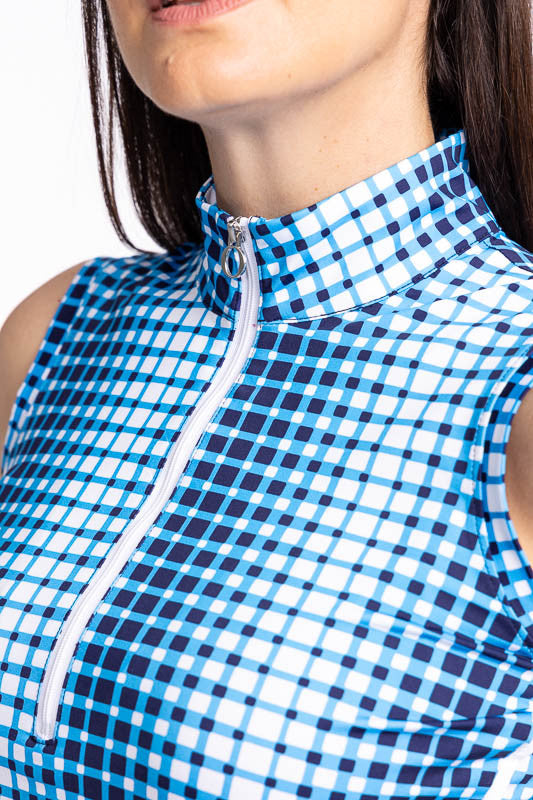 Close front view of the quarter zip front and collar on the Keep It Covered Sleeveless Golf Top in Ocean Plaid. The ocean plaid print is a vertical repeating gradient white to blue checkered print. The top features a white quarter zip front and two white 