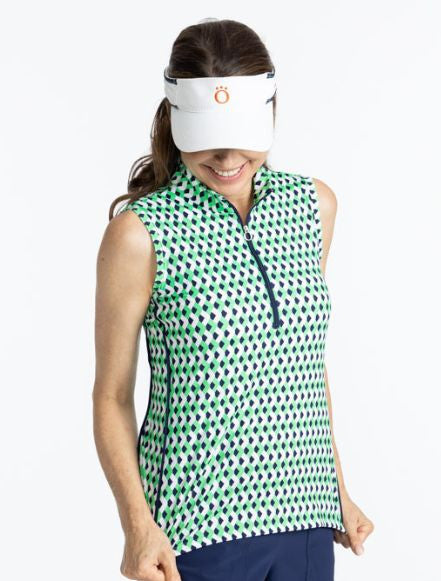 Woman golfer wearing the Keep It Covered Sleeveless Golf Top in Chevron Kelly Green. This top has a quarter zip navy blue zipper on the front and two thin, navy blue stripes down each side of this top.