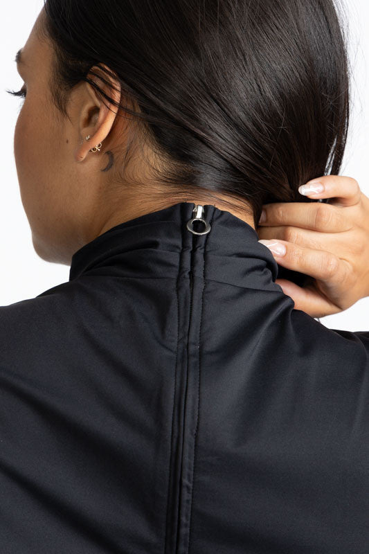 Close back view of the zipper on the Twist and Shout Sleeveless Golf Top in Black. 