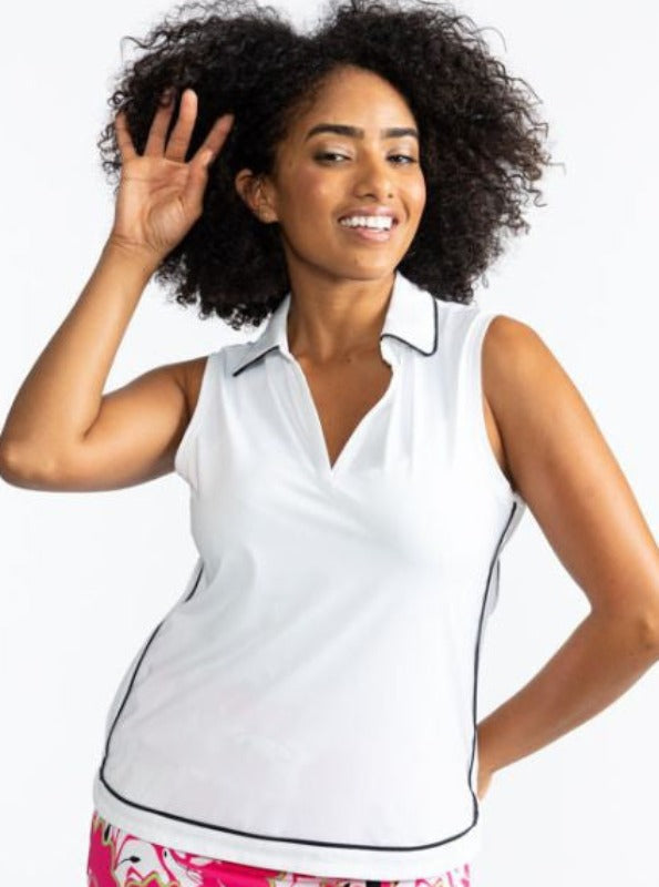 Front view of a smiling woman wearing the Bogey Round Sleeveless Golf Top in White. This top is trimmed in black around the collar and the outer edges of this top.