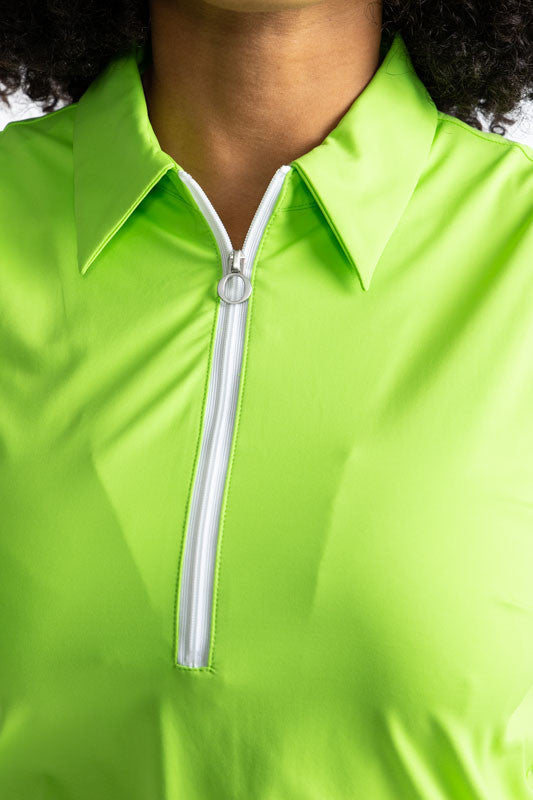 Close front view of the neckline on the In Play Sleeveless Golf Dress in Grass Green. This dress is primarily grass green with a thin band of black near the bottom, followed by a thicker section of white at the bottom of this dress.