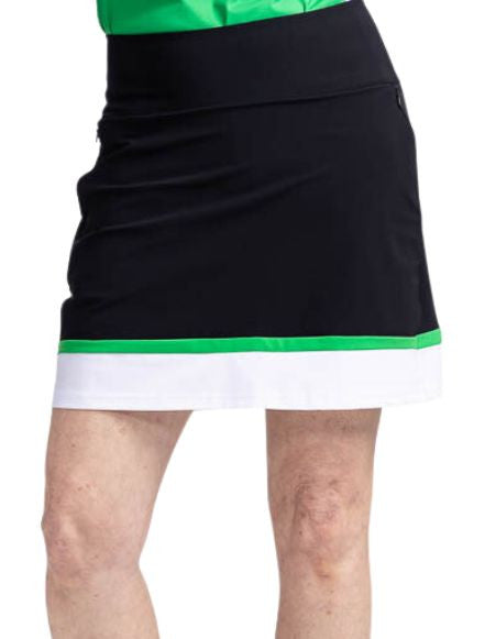 Close front view of the In Play Golf Skort in Black/Green. This is a predominantly black skort with a thin band of green followed by a wide band of white at the bottom of the skort.